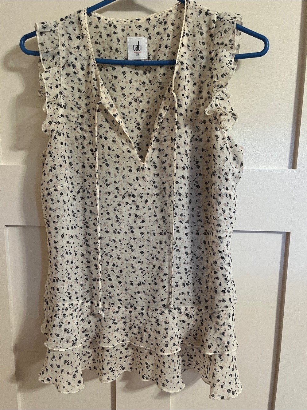 Cabi sleeveless blouse. Ivory with black/navy floral print. Size XS. EUC